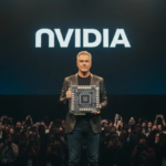 NVIDIA executive holding an advanced AI graphics chip during a technology presentation