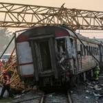 Rescue workers at the crash site where a construction crane collapsed onto a passenger train in Nakhon Ratchasima, Thailand